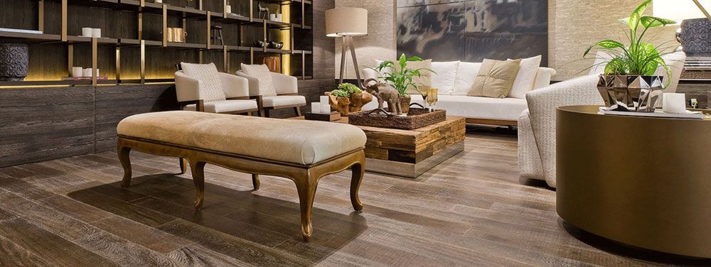 hardwood flooring in living room with plants and bronze shelving